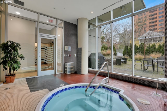 view of pool featuring a grill and an indoor in ground hot tub