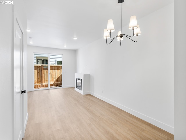 6611 N Fessenden St, Portland, OR 97203 - unfurnished living room with light wood-style flooring, baseboards, a chandelier, and recessed lighting