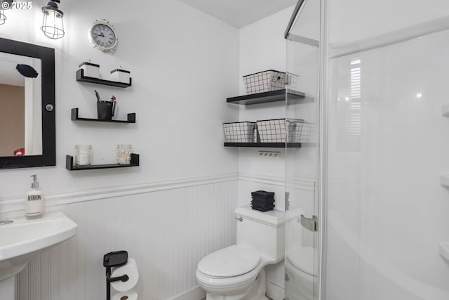 18430 SW Broad Oak Blvd, Beaverton, OR 97007 - bathroom featuring toilet, a shower with shower door, and a wainscoted wall