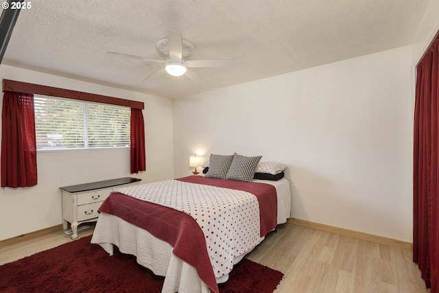 18430 SW Broad Oak Blvd, Beaverton, OR 97007 - bedroom featuring light wood-style floors, baseboards, a textured ceiling, and ceiling fan