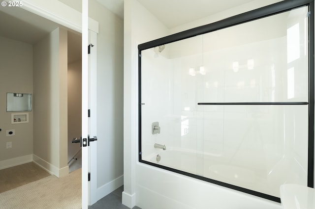 bathroom featuring combined bath / shower with glass door