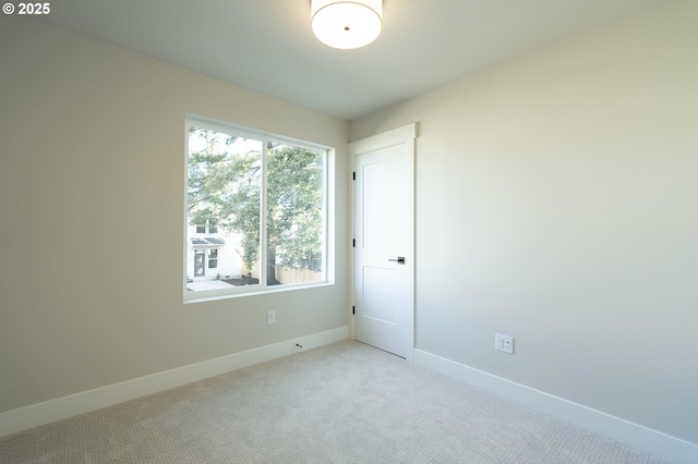 unfurnished room with light colored carpet