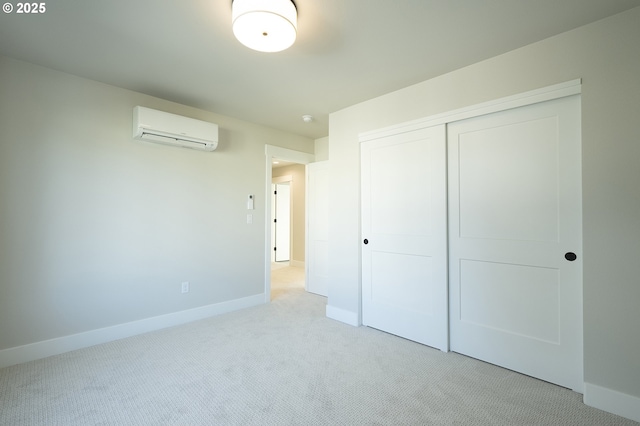 unfurnished bedroom featuring a closet, a wall mounted air conditioner, and light carpet