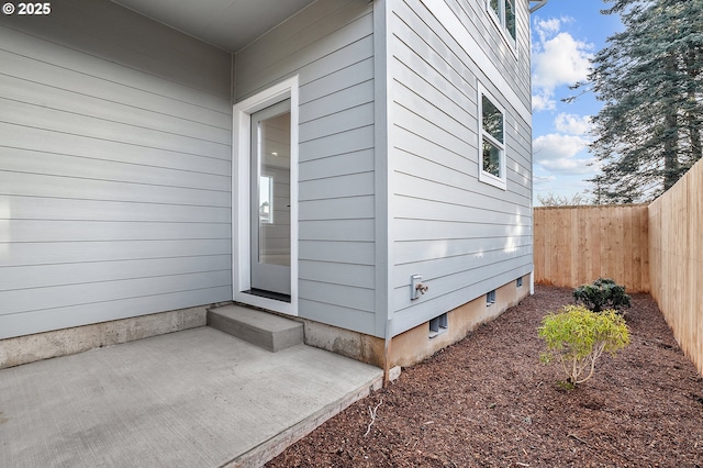 view of exterior entry featuring a patio area