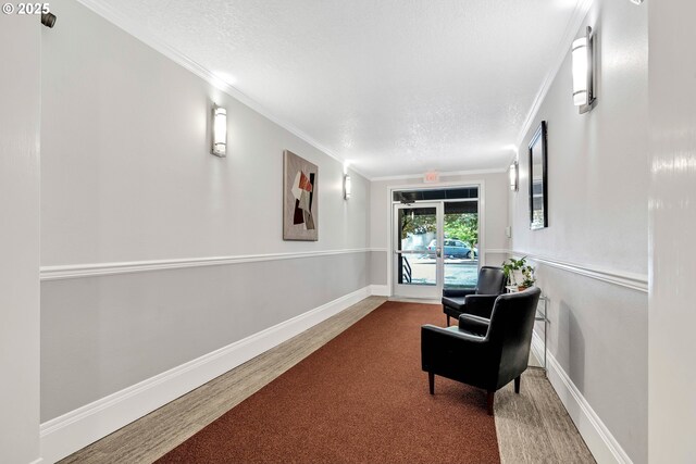 4320 S Corbett Ave Unit 302, Portland, OR 97239 - hall with a textured ceiling, carpet, ornamental molding, and baseboards
