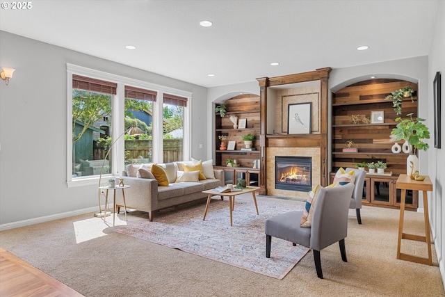 carpeted living room featuring a tile fireplace, baseboards, and recessed lighting