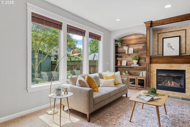living room with baseboards, a fireplace, recessed lighting, and carpet