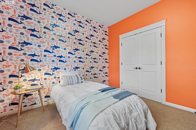 bedroom with carpet flooring, a closet, and baseboards