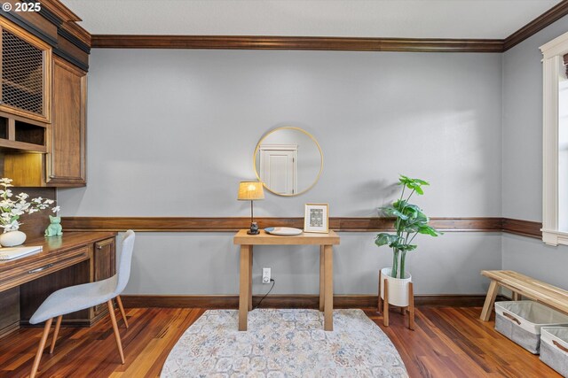 home office with ornamental molding, wood finished floors, and baseboards