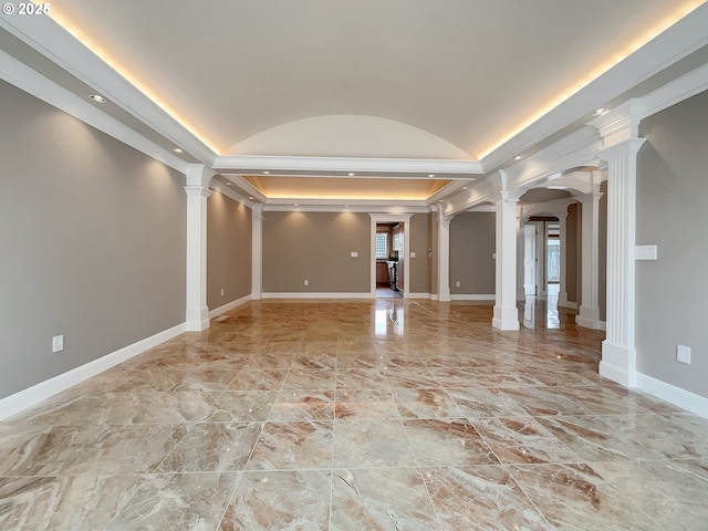 spare room with arched walkways, baseboards, vaulted ceiling, and ornate columns