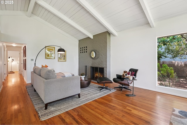 311 NE 130th Pl, Portland, OR 97230 - living area featuring wood finished floors, a fireplace, beamed ceiling, high vaulted ceiling, and baseboards