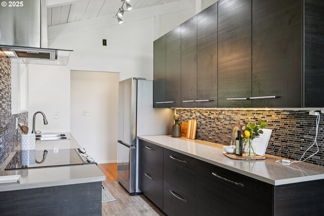311 NE 130th Pl, Portland, OR 97230 - kitchen with modern cabinets, decorative backsplash, a sink, light wood-style flooring, and light countertops