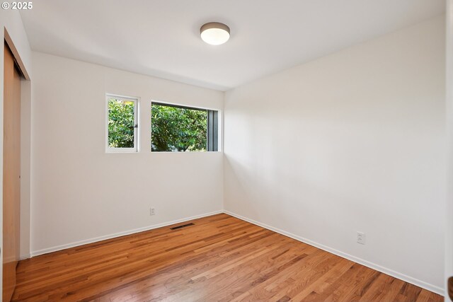 311 NE 130th Pl, Portland, OR 97230 - unfurnished bedroom with a closet, baseboards, and light wood-style flooring