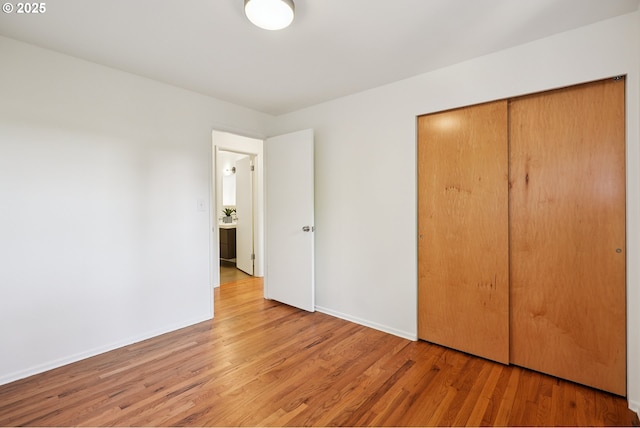 311 NE 130th Pl, Portland, OR 97230 - unfurnished bedroom with wood finished floors, a closet, and baseboards