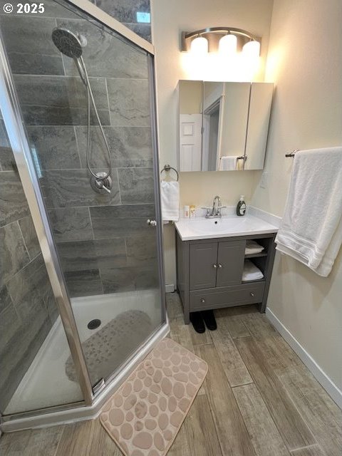 bathroom featuring vanity and an enclosed shower