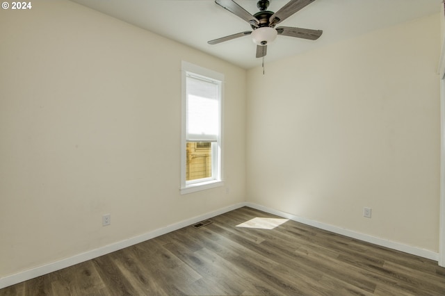 spare room with ceiling fan and dark hardwood / wood-style flooring