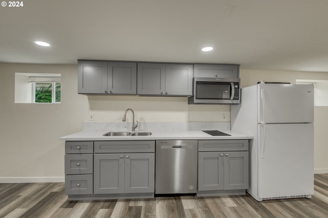 kitchen with stainless steel appliances, dark hardwood / wood-style flooring, gray cabinets, and sink