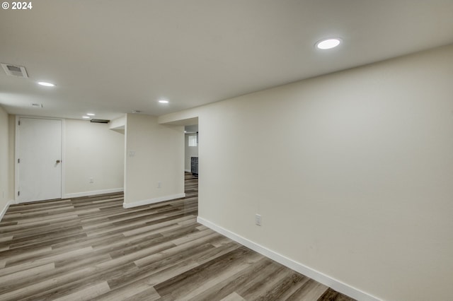 basement with light hardwood / wood-style floors