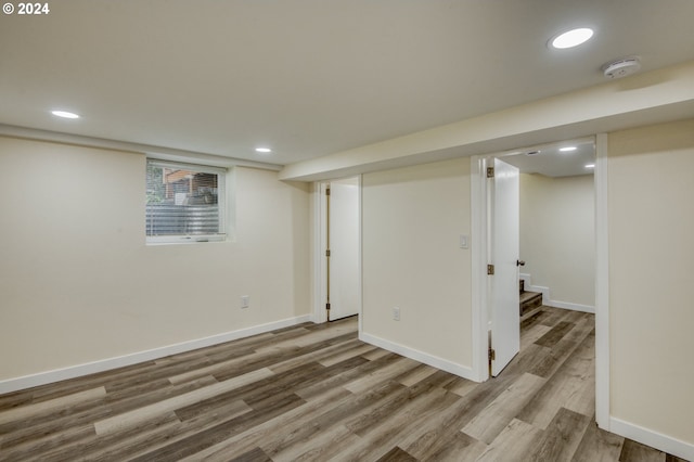 basement with light hardwood / wood-style floors