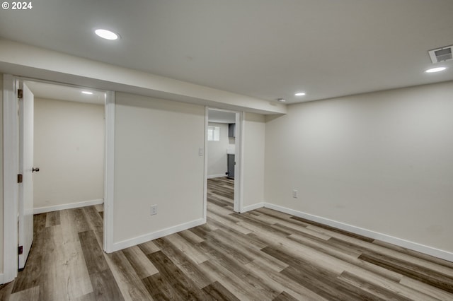 basement with light hardwood / wood-style flooring