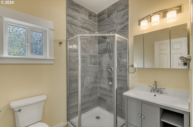 bathroom with vanity, an enclosed shower, and toilet