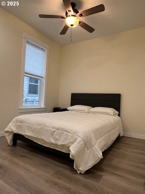 bedroom with ceiling fan and wood-type flooring