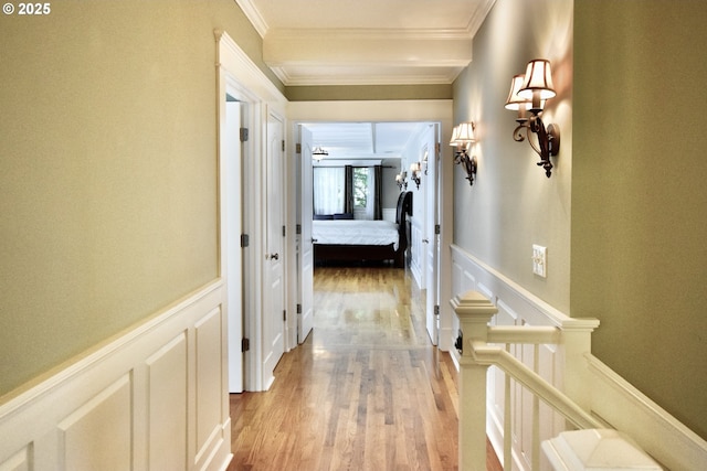 2917 NE 9th Ave, Portland, OR 97212 - hallway featuring crown molding, a decorative wall, light wood-style flooring, and a wainscoted wall