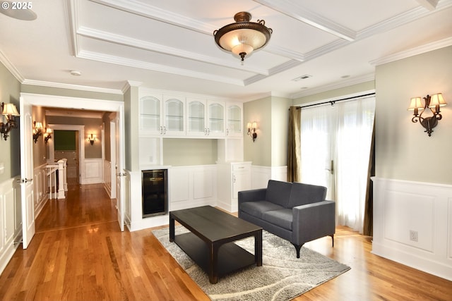 2917 NE 9th Ave, Portland, OR 97212 - living room featuring beverage cooler, a decorative wall, a wainscoted wall, light wood-style flooring, and crown molding