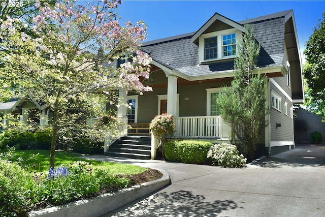2917 NE 9th Ave, Portland, OR 97212 - view of front of home featuring covered porch, a shingled roof, and stairs