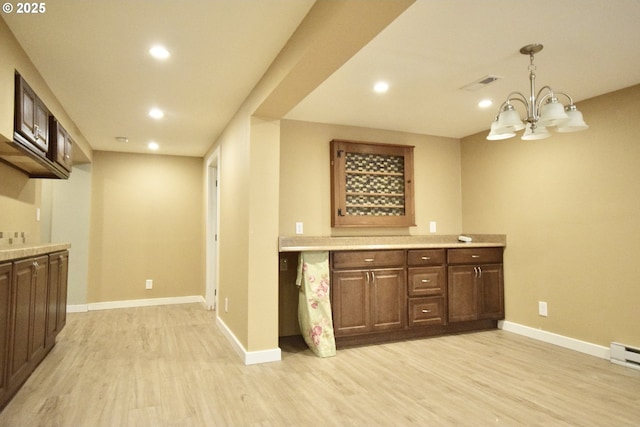 2917 NE 9th Ave, Portland, OR 97212 - bar area with light wood finished floors, baseboards, recessed lighting, a chandelier, and pendant lighting