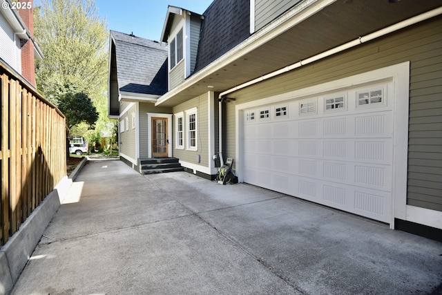2917 NE 9th Ave, Portland, OR 97212 - view of side of home featuring roof with shingles, concrete driveway, and a garage