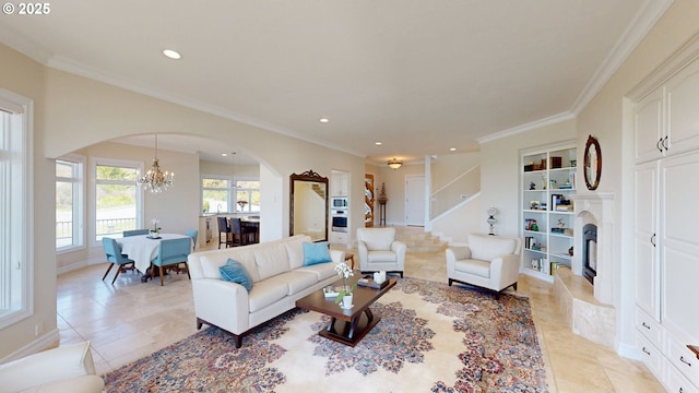 96424 Shorewood Ter, Brookings, OR 97415 - living room featuring arched walkways, recessed lighting, an inviting chandelier, a fireplace with raised hearth, and crown molding