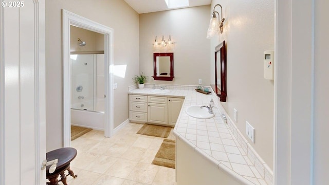 96424 Shorewood Ter, Brookings, OR 97415 - bathroom featuring a skylight, combined bath / shower with glass door, vanity, and tile patterned flooring