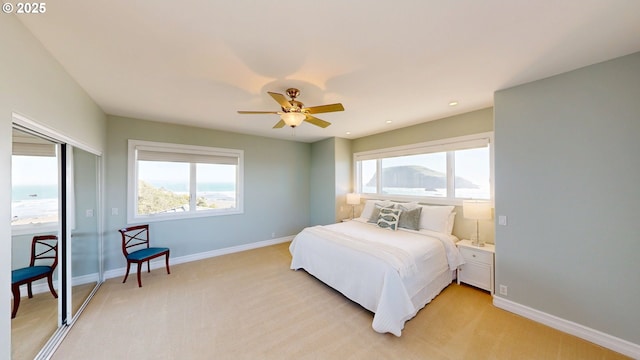 96424 Shorewood Ter, Brookings, OR 97415 - bedroom featuring light carpet, baseboards, and multiple windows