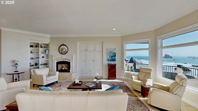 96424 Shorewood Ter, Brookings, OR 97415 - living room featuring a high end fireplace, a water view, ornamental molding, baseboards, and built in shelves
