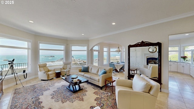 96424 Shorewood Ter, Brookings, OR 97415 - living room with recessed lighting, arched walkways, a water view, and ornamental molding