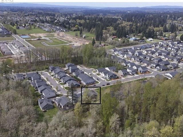 birds eye view of property featuring a residential view and a view of trees