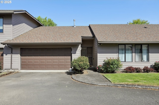 12604 NE Prescott Dr, Portland, OR 97230 - view of front of home featuring an attached garage, asphalt driveway, roof with shingles, and a front yard