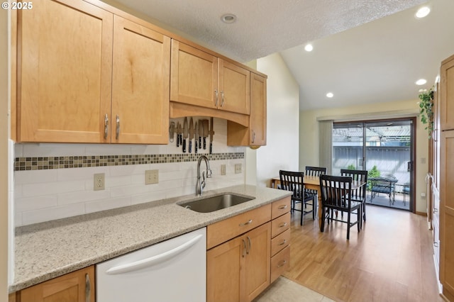 12604 NE Prescott Dr, Portland, OR 97230 - kitchen featuring dishwasher, a sink, tasteful backsplash, vaulted ceiling, and light stone countertops
