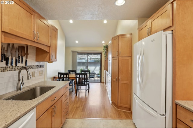 12604 NE Prescott Dr, Portland, OR 97230 - kitchen with white appliances, a sink, backsplash, light stone countertops, and light wood-style floors