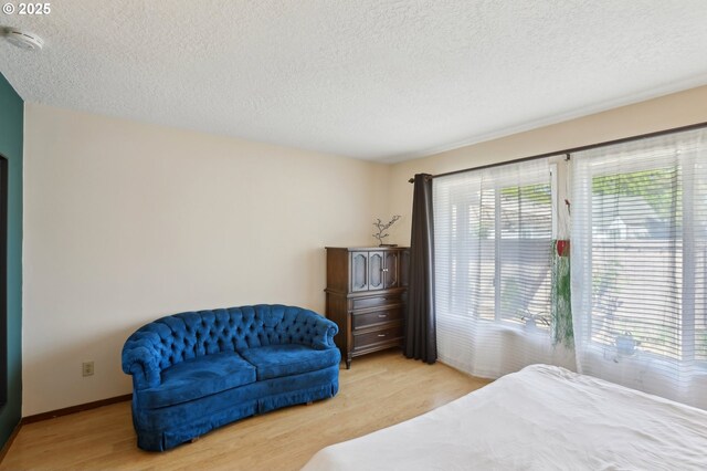 12604 NE Prescott Dr, Portland, OR 97230 - bedroom featuring wood finished floors and a textured ceiling