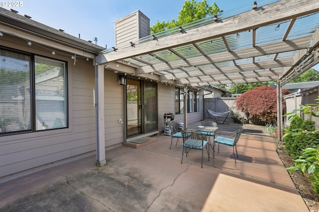 12604 NE Prescott Dr, Portland, OR 97230 - view of patio with outdoor dining space, fence, and a pergola