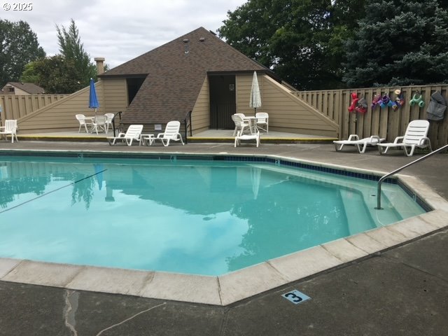 12604 NE Prescott Dr, Portland, OR 97230 - community pool with a fenced backyard and a patio