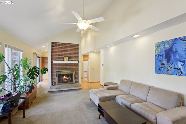 12604 NE Prescott Dr, Portland, OR 97230 - carpeted living room with high vaulted ceiling, a ceiling fan, a brick fireplace, and recessed lighting