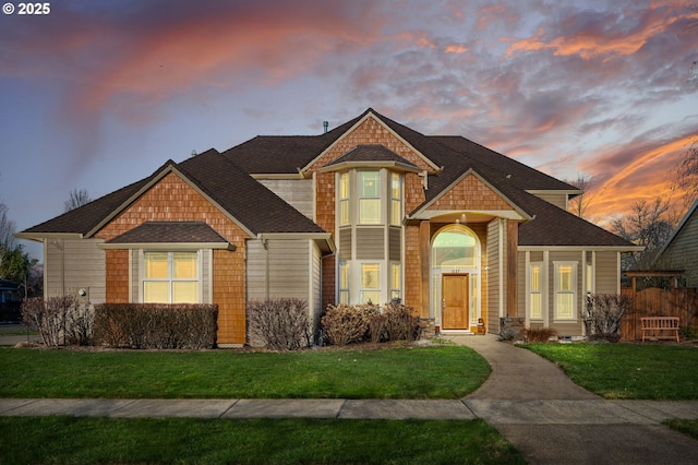 view of front facade featuring a front yard and fence