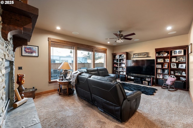 carpeted living room featuring a ceiling fan, recessed lighting, and a fireplace