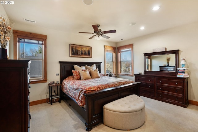 bedroom featuring baseboards, visible vents, and light colored carpet