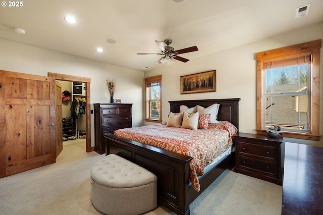 bedroom with visible vents, a ceiling fan, light colored carpet, a spacious closet, and recessed lighting