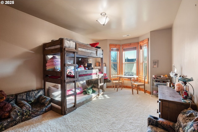 bedroom featuring carpet, visible vents, and baseboards