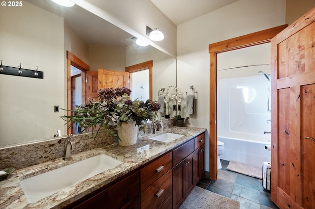 full bathroom featuring bathtub / shower combination, a sink, toilet, and double vanity